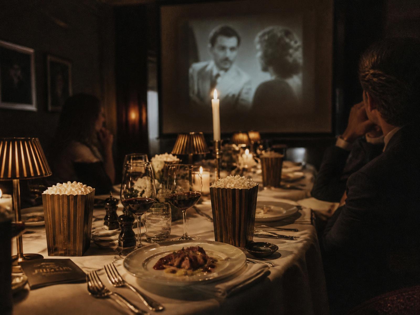 An intimate candlelit film night dinner